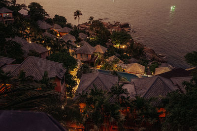 High angle view of houses by sea during sunset