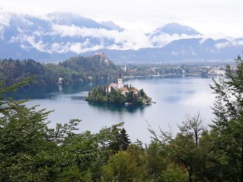 Scenic view of lake and mountains against sky