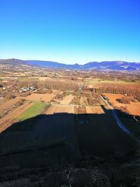 Aerial view of landscape against blue sky