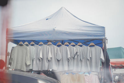 Clothes drying on clothesline against white background