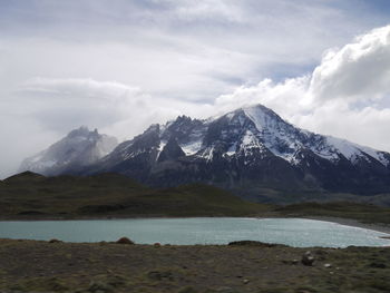 Scenic view of mountains against cloudy sky