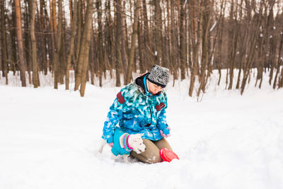 Full length of child on snow covered field