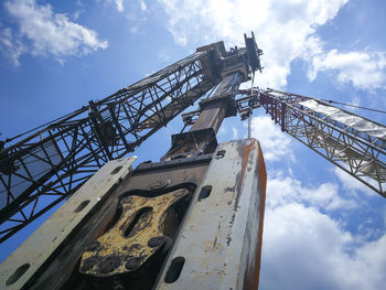 Low angle view of crane against sky