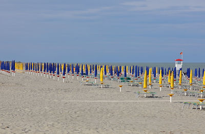 Wooden posts on beach against sky