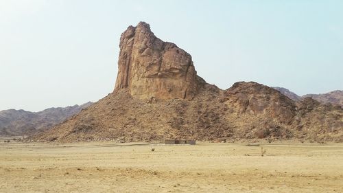 Scenic view of stack rock in desert against sky