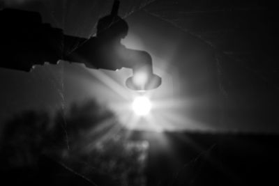 Close-up of hands against sun shining in sunlight