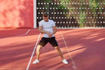 Full length of man playing tennis