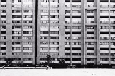 Reflection of man on building in city