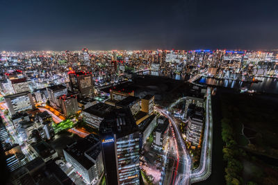 High angle view of illuminated cityscape against sky at night