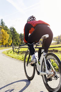 Side view of man riding bicycle