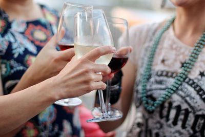 Midsection of woman drinking glass