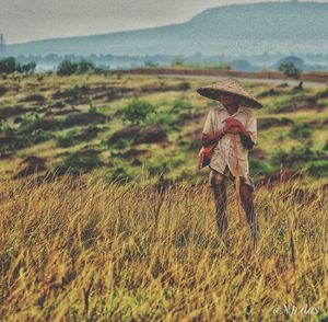 View of person walking on grassy field