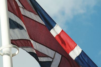 Low angle view of flag against sky