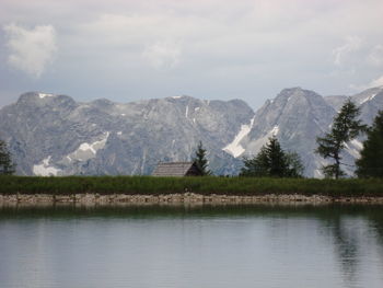 Scenic view of lake and mountains against sky