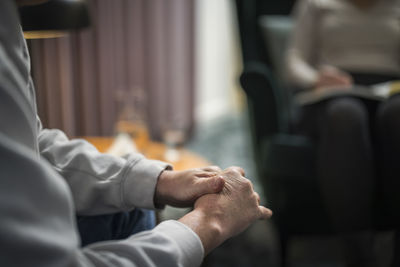 Man wringing hands at therapy session