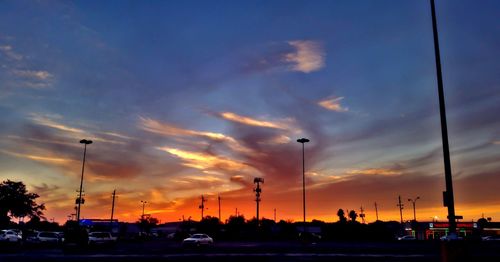 Silhouette city against sky at sunset