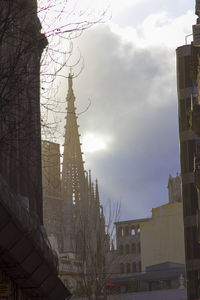 Low angle view of church against cloudy sky