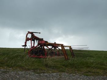 Traditional windmill on field against sky