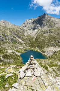 Aerial view of a beautiful lake surrounded by the dolomites mountain range in summertime