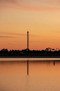 Scenic view of lake against orange sky