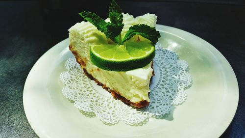 High angle view of fresh key lime pie served in plate