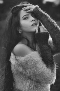 Portrait of young woman looking away outdoors