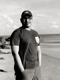 Portrait of man standing at beach