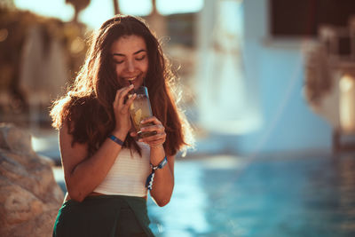 Portrait of a smiling young woman standing outdoors