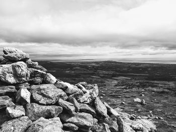 Scenic view of rocks on landscape against sky