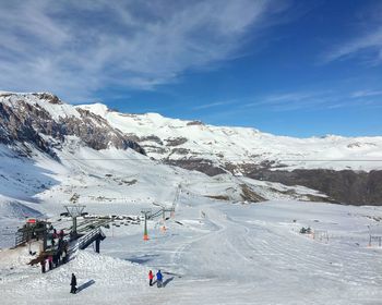 Tourists on snow covered landscape