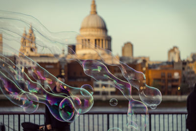 Bubbles against cathedral in city