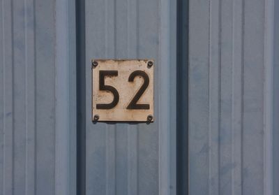 Close-up of number 52 on door