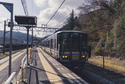 Train at railroad station against sky