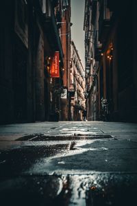 Puddle on the street with reflection in low ancle view in barcelona gothic quarter 