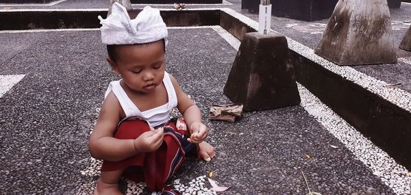 High angle view of cute girl sitting outdoors