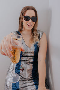 Young woman wearing sunglasses and drink on table