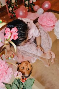 High angle view of cute girl sitting on floor at home