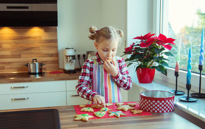 Girl eating cookies at home