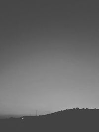 Silhouette landscape against clear sky