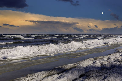 Scenic view of winter sea against sky during full moon 