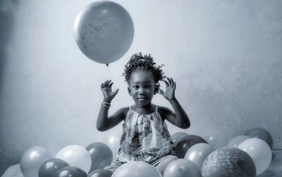 Portrait of girl playing with balloon