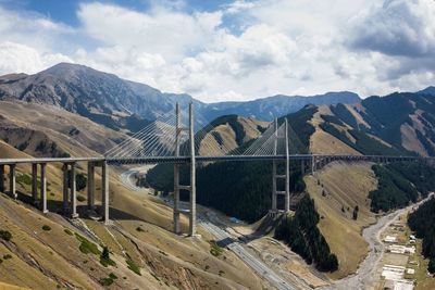 Guozigoui bridge by mountains against sky