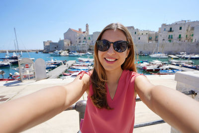 Portrait of smiling young woman in city