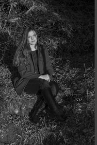 Portrait of young woman sitting outdoors