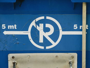 Close-up of arrow sign on road