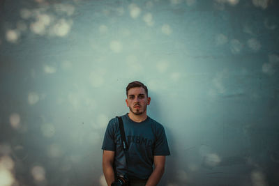 Portrait of young man against wall