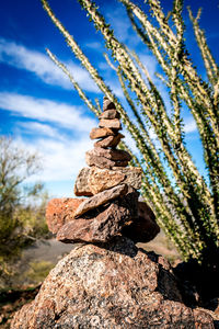Close-up of stack of rock against sky