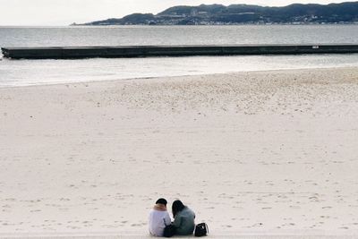 Rear view of couple on beach