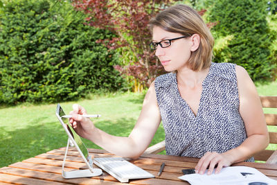 Young woman sitting on table