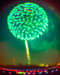 Low angle view of illuminated lighting equipment at night